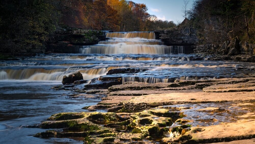 Aysgarth Falls flowing over limestone steps in the Yorkshire Dales